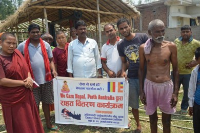 Relief distribution under a We Care Nepal Perth Australia banner in Bara district