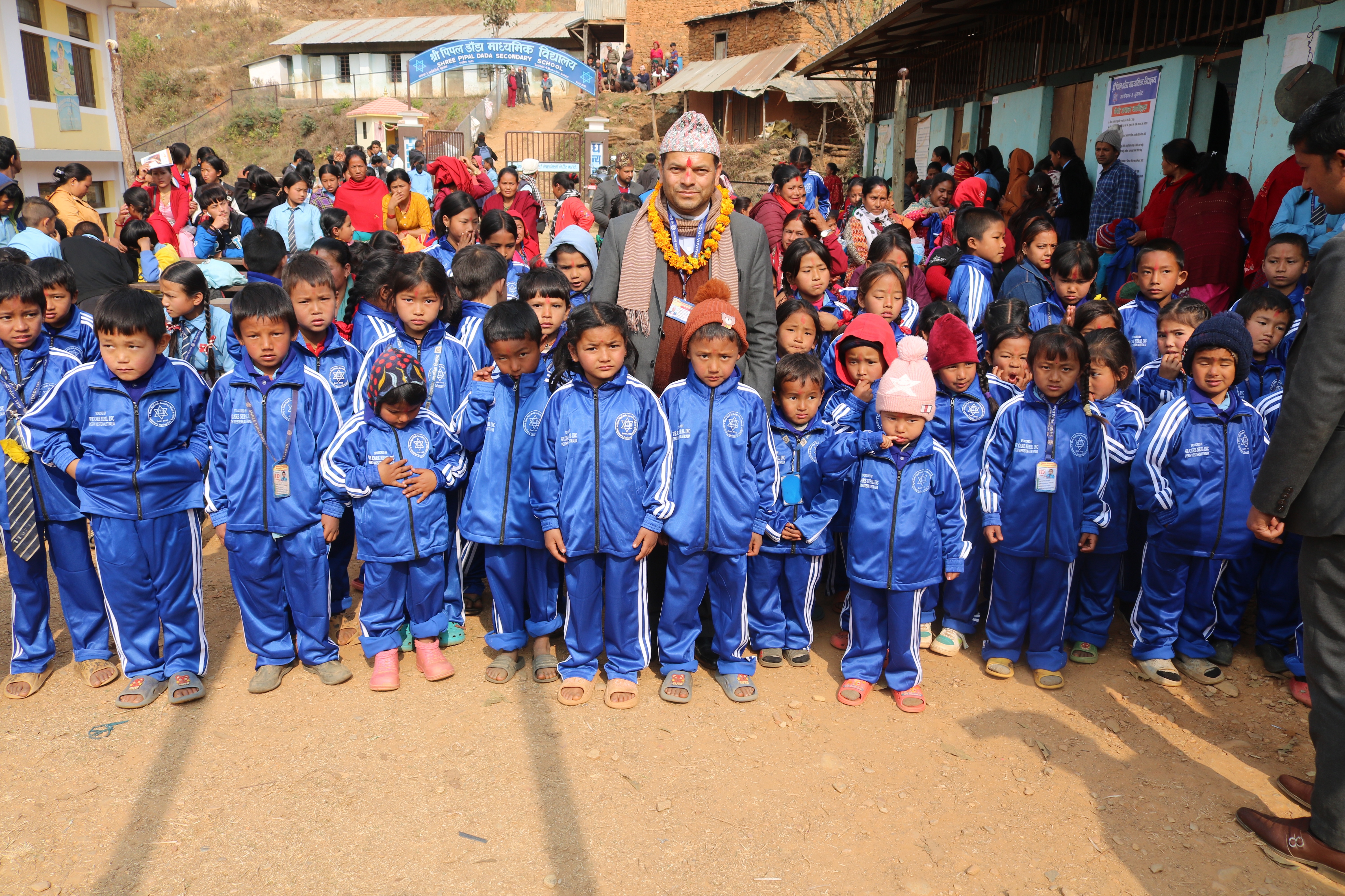 Relief distribution under a We Care Nepal Perth Australia banner in Bara district