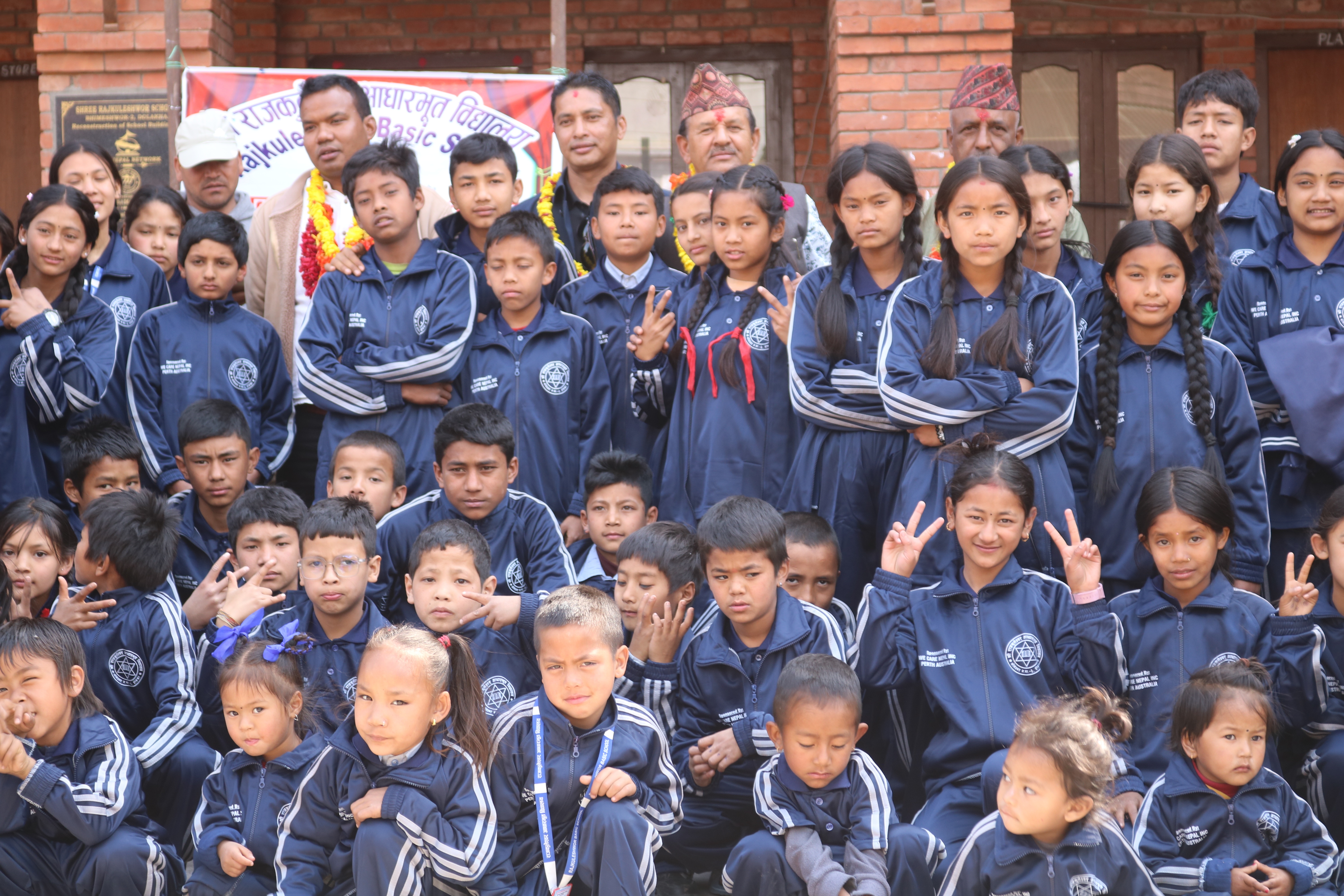 Relief distribution under a We Care Nepal Perth Australia banner in Bara district