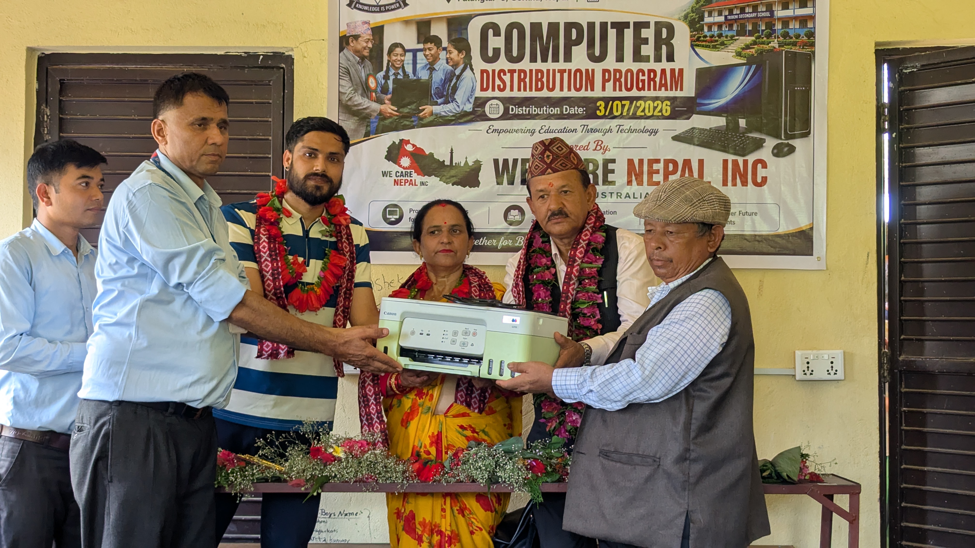 Relief distribution under a We Care Nepal Perth Australia banner in Bara district