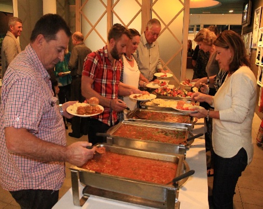 Guests serving themselves from the buffet at the second charity dinner